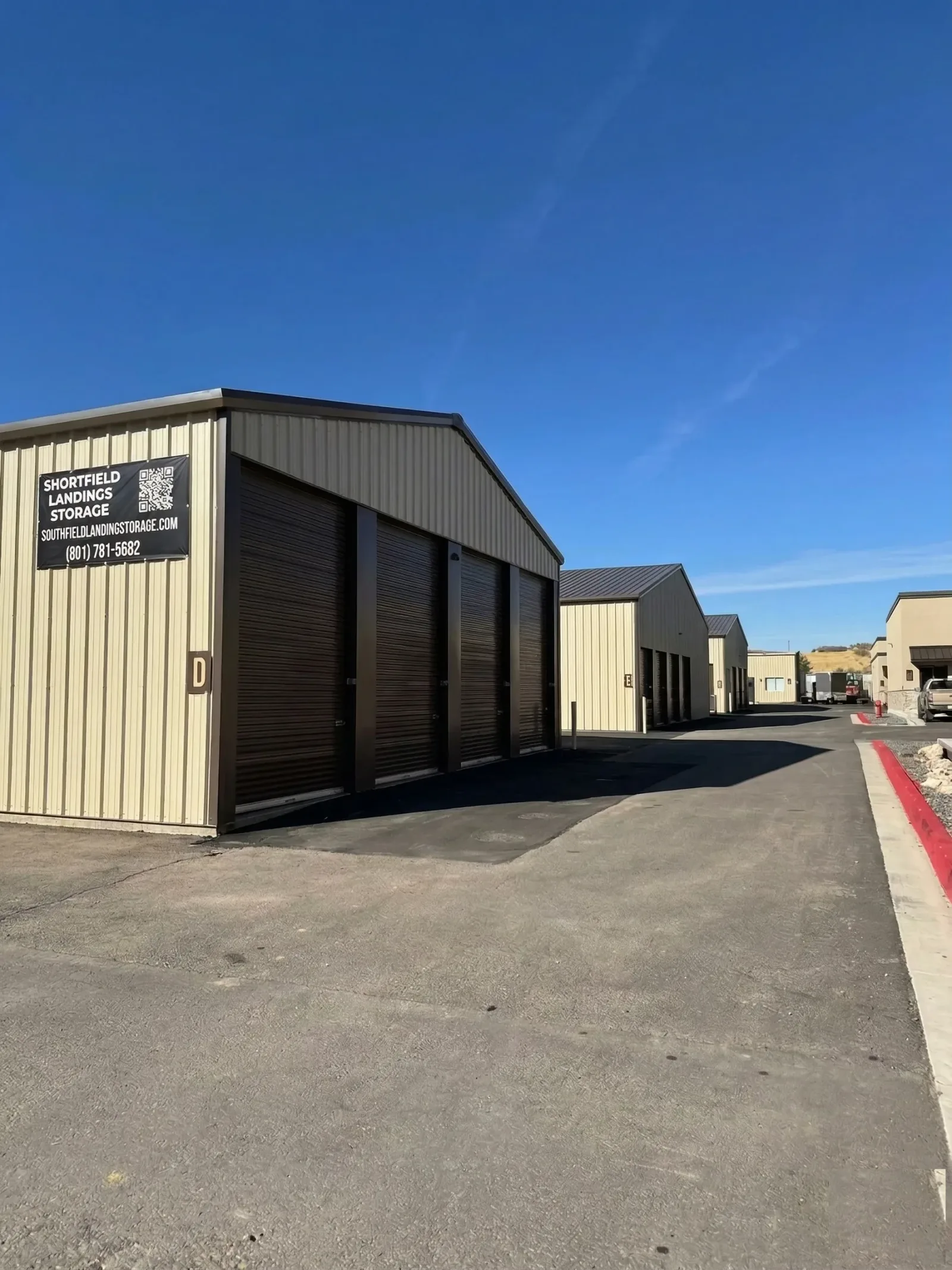 Shortfield Landings self-storage facility ground-level exterior with branded entrance signage